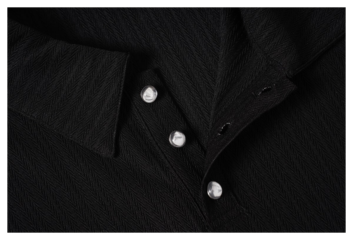 Close-up of the black shirt collar and button placket, showing the textured fabric and buttonholes.