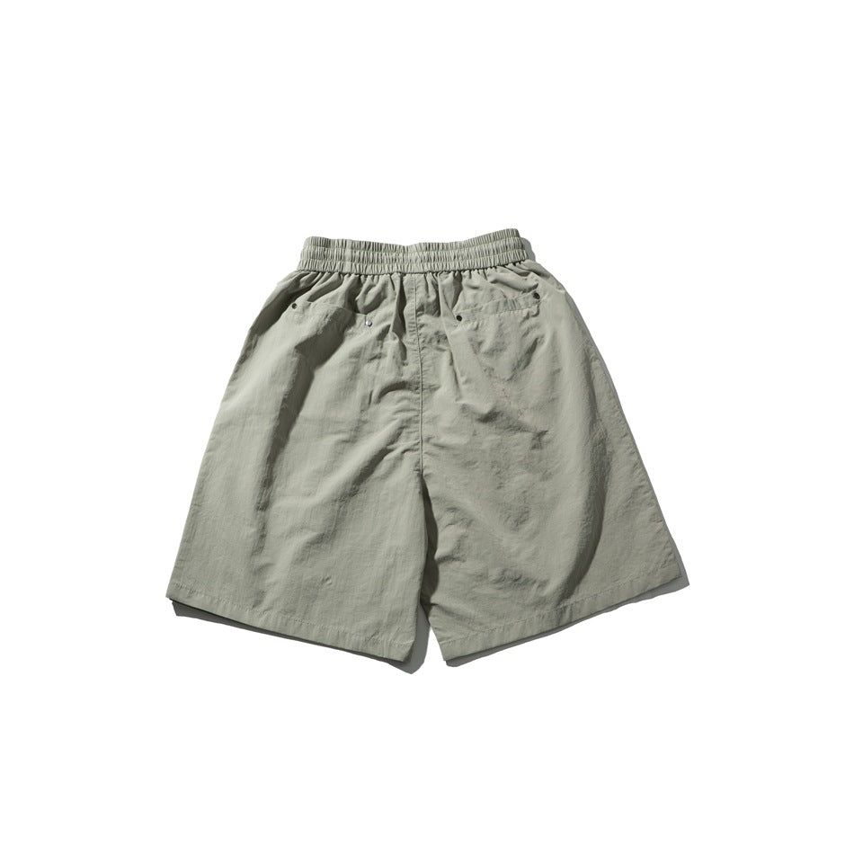 Back view of light gray-green shorts laid flat, with an elastic waistband and rear pockets.