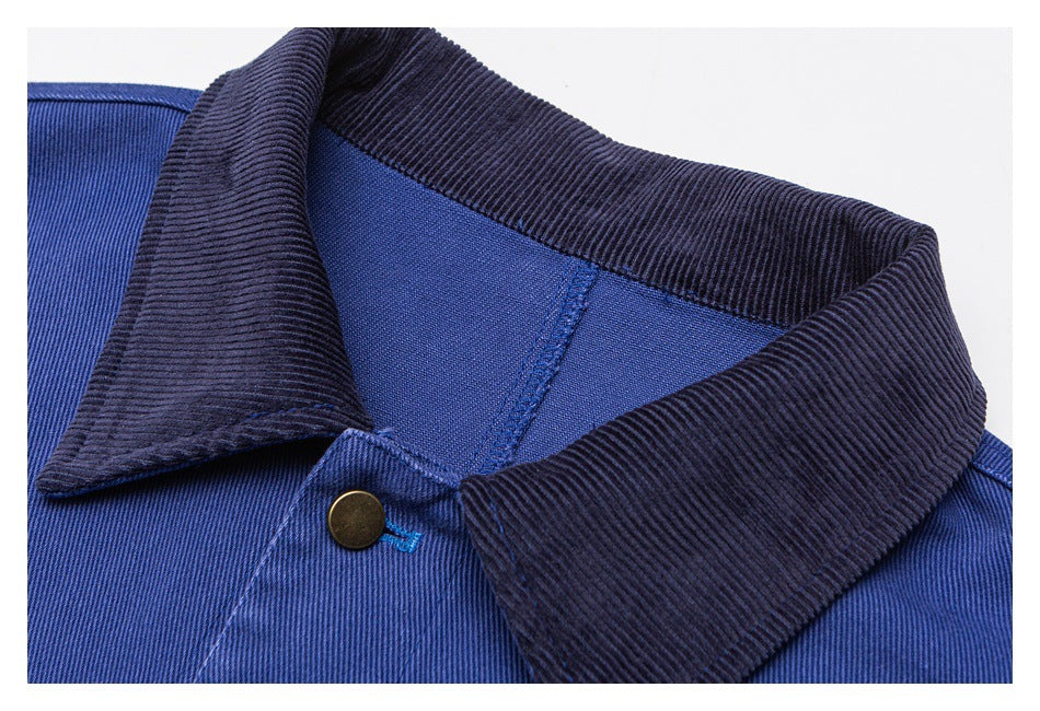 Close-up of the jacket's dark ribbed collar, blue fabric, and brass-tone front button.
