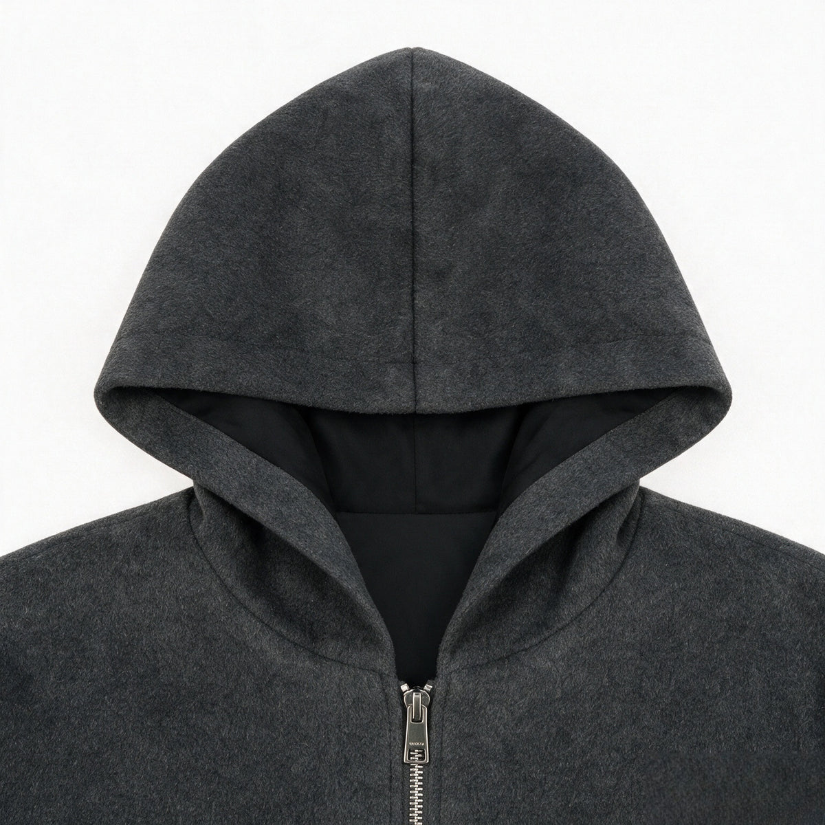 Close-up of a charcoal gray hood and upper front of a zip-up jacket, showing black lining and a metal zipper.
