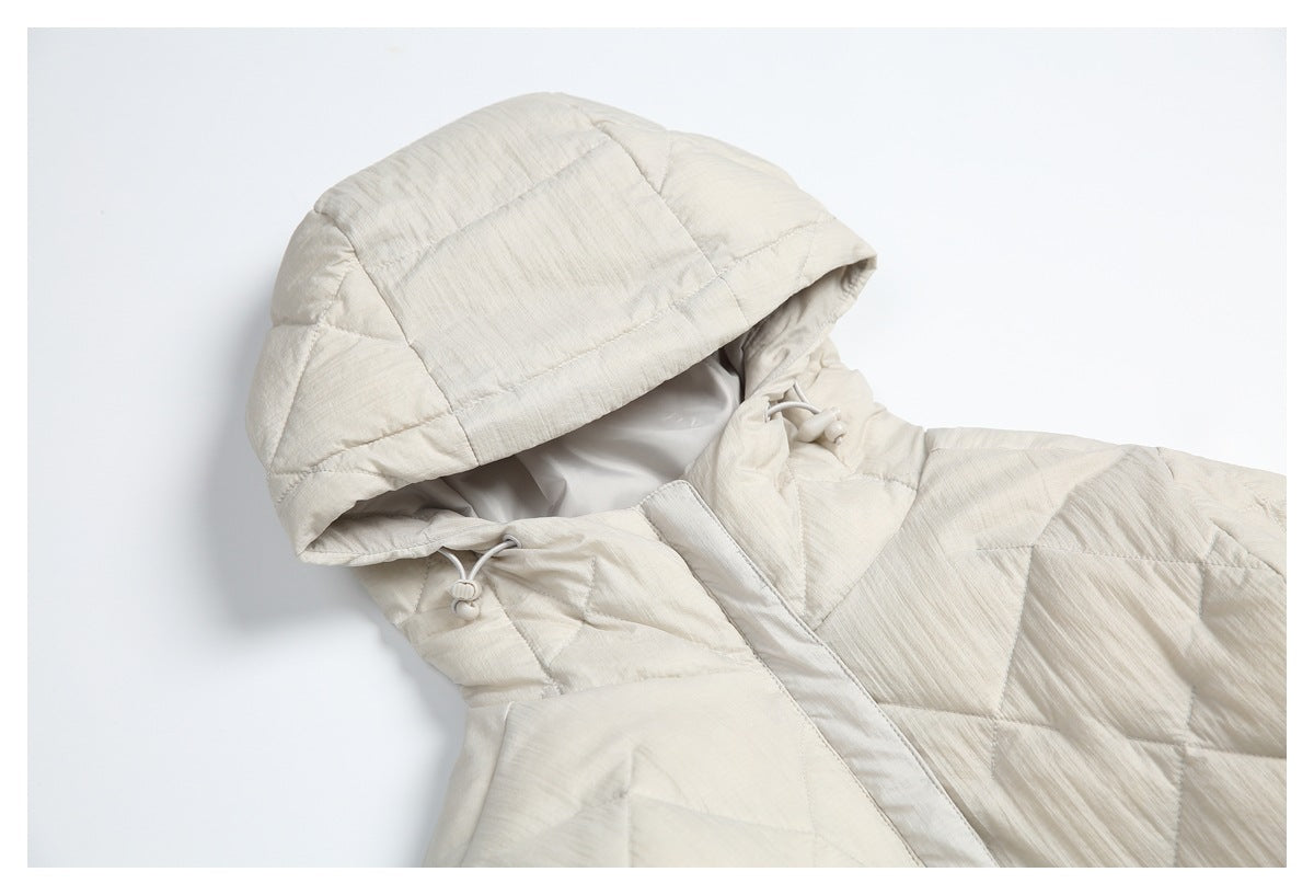 Close view of an ivory quilted coat hood, drawcords, and front opening.