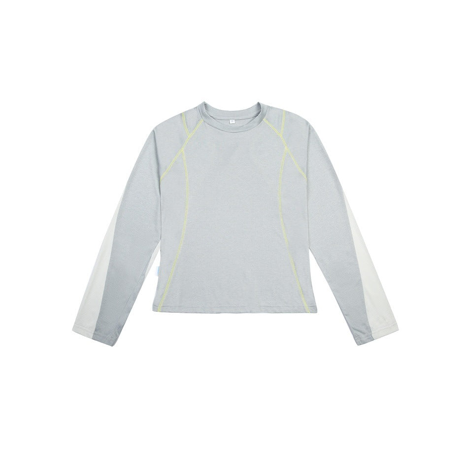 Light gray-green long-sleeve top with yellow-green topstitching and off-white sleeve panels, flat front view