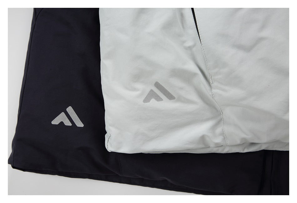 Close-up of light gray and black garments with matching geometric logos.