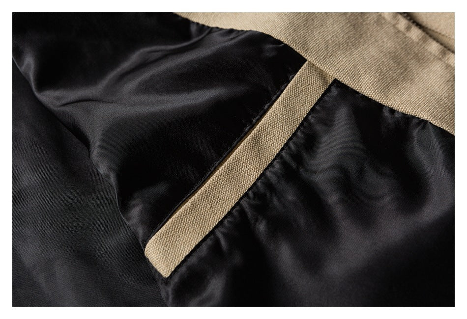 Close-up of black jacket lining and a beige fabric seam.