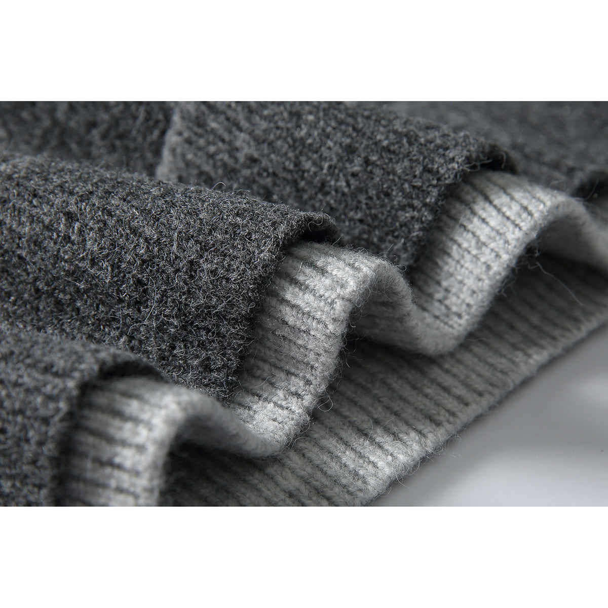 Close-up showing the charcoal knit sweater fabric and contrasting light gray ribbed trim.