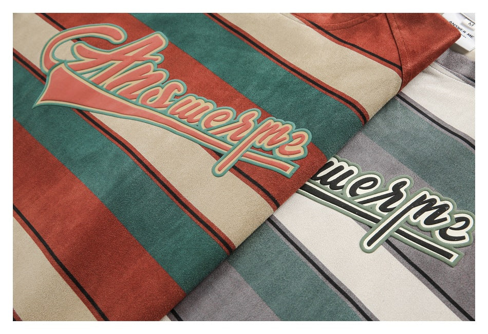 Close-up of raised script lettering on rust-red and gray striped T-shirts.