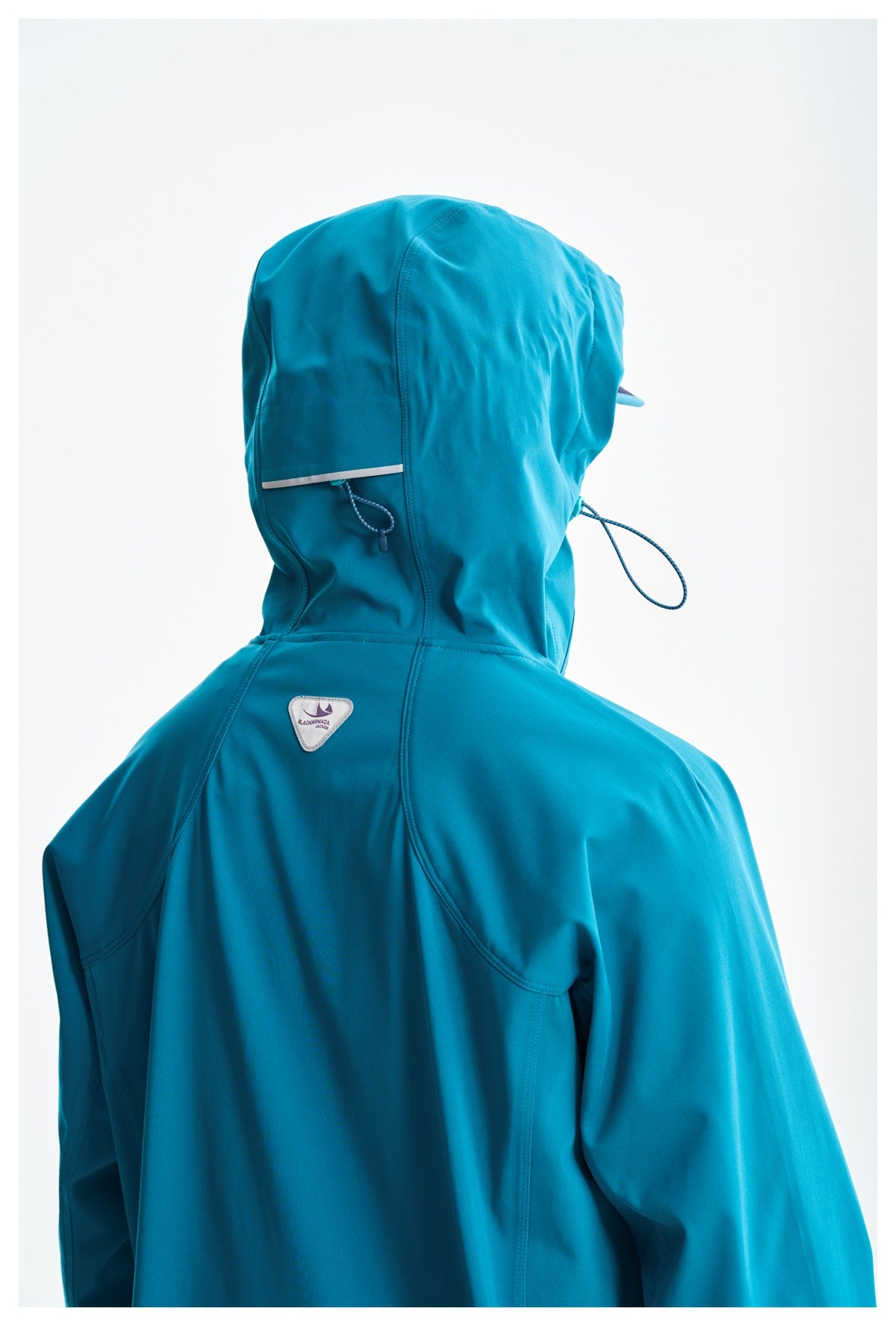 Back close-up of the teal jacket showing the hood, drawcord, reflective strip, and shoulder seams.