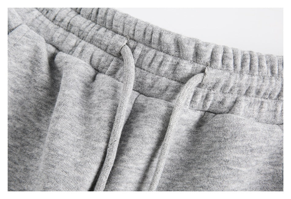 Close-up of the heather gray pants' gathered elastic waistband and matching drawstring.