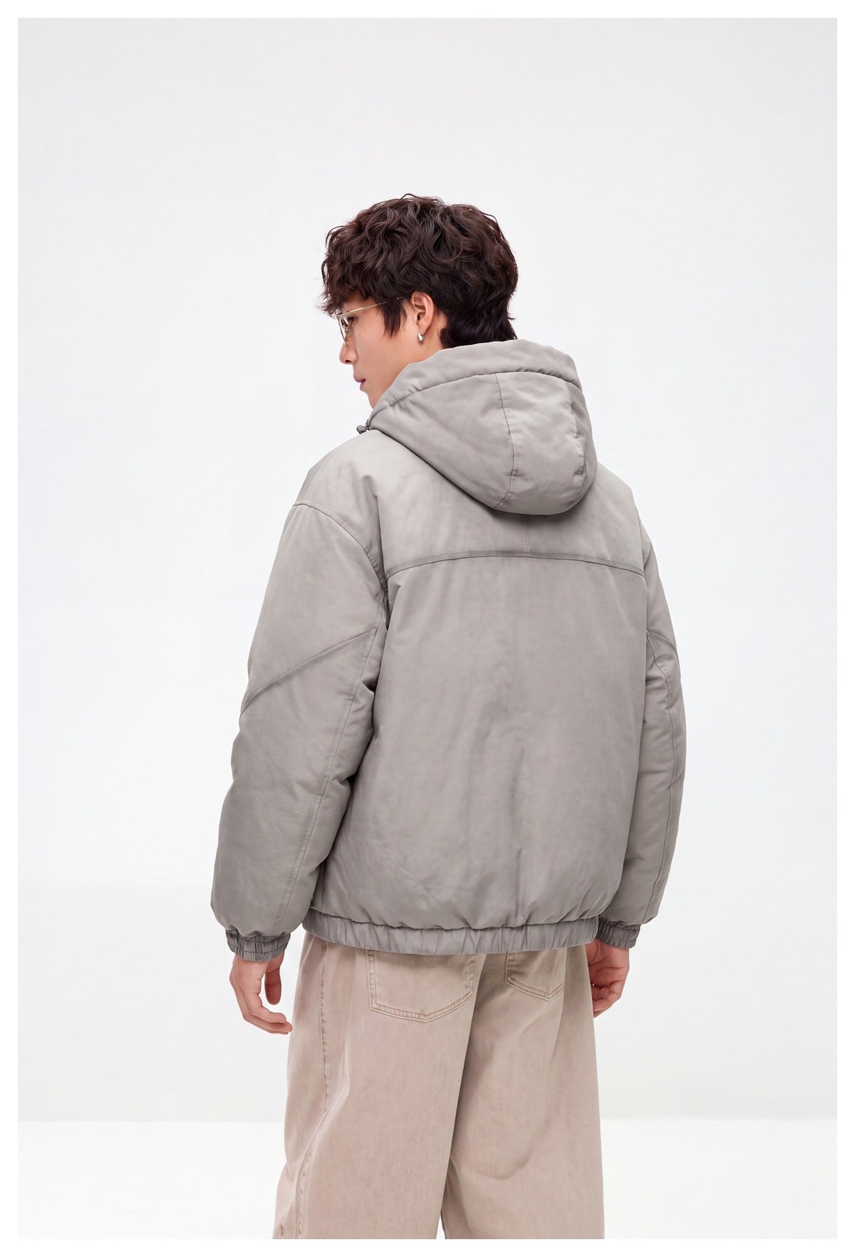 Model wearing a light gray hooded jacket, shown from the back with the hood down.
