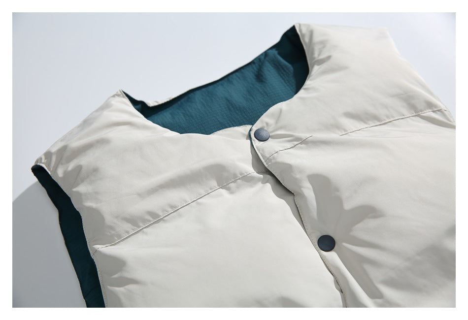 Close-up of a white garment's collar and dark snap-button placket, with teal lining visible inside.