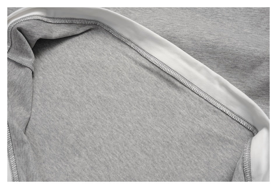 Inside close-up showing gray overlock stitching and white trim along a garment seam.
