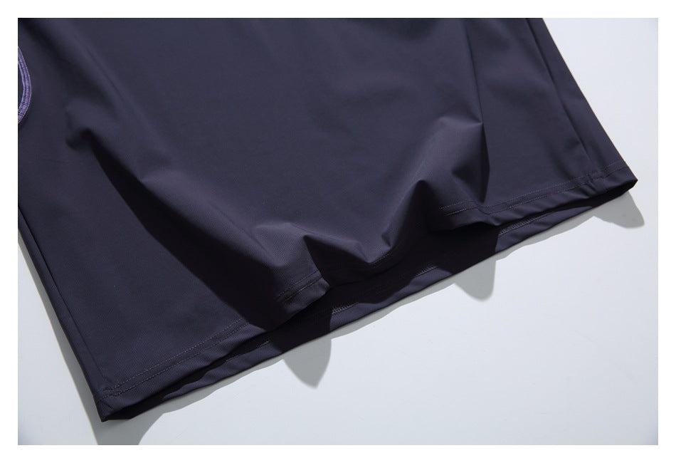 Close-up of the dark navy T-shirt's stitched bottom hem.