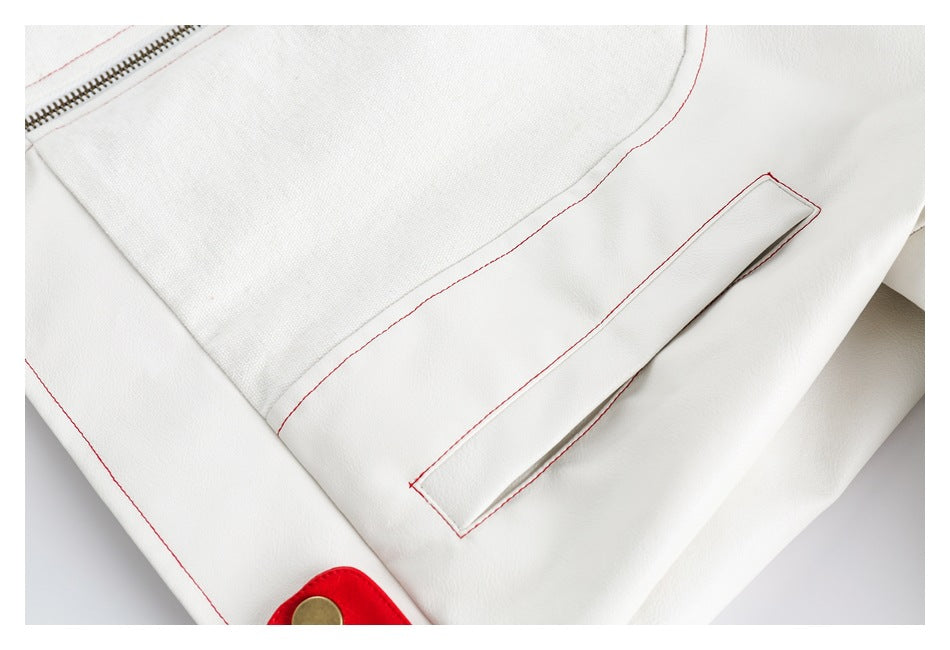 Close-up of a narrow welt pocket and red stitching on the off-white jacket.