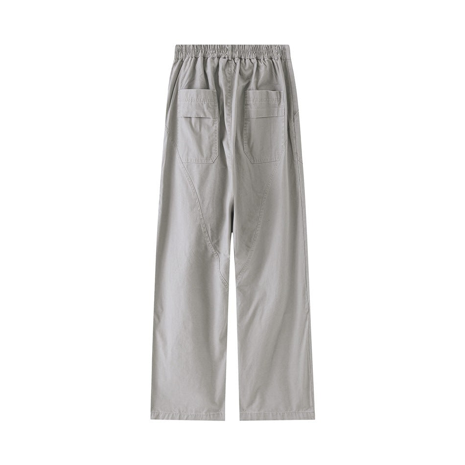 Light gray wide-leg pants flat lay, back view with elastic waistband, two flap back pockets and curved seams