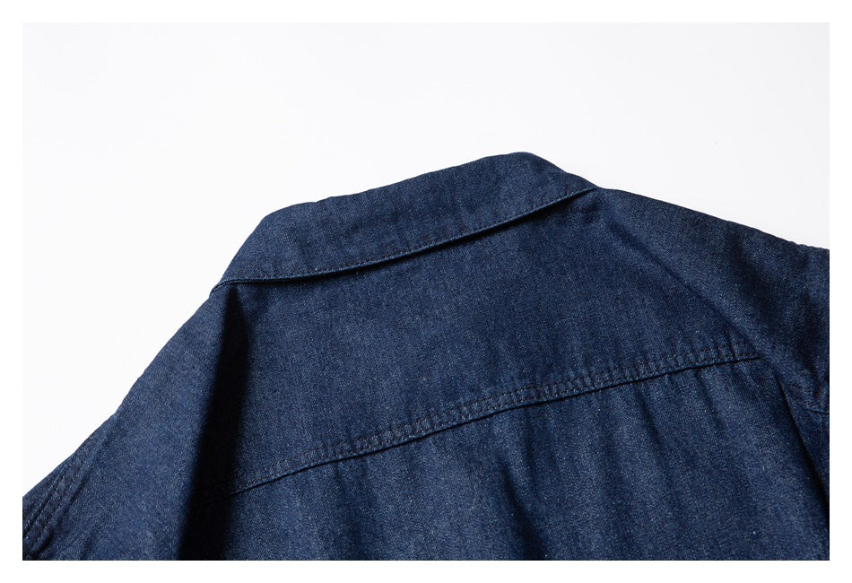 Close-up of the back collar and yoke seam on a dark indigo shirt.