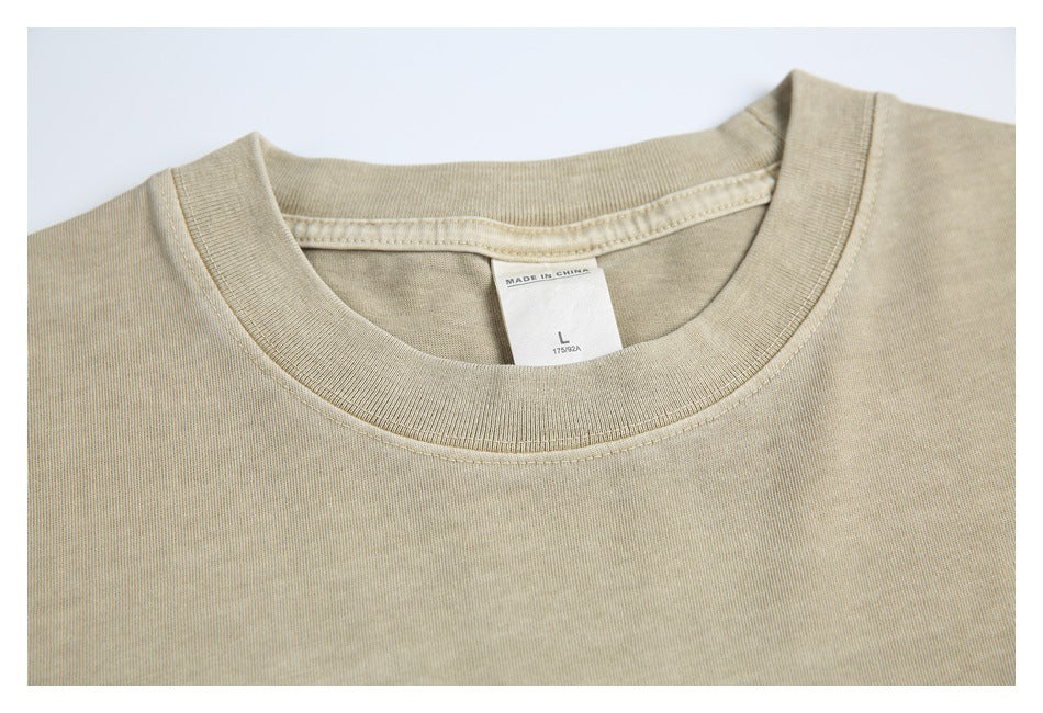 Close-up of the beige T-shirt's ribbed crew neckline and inner label marked size L and Made in China.