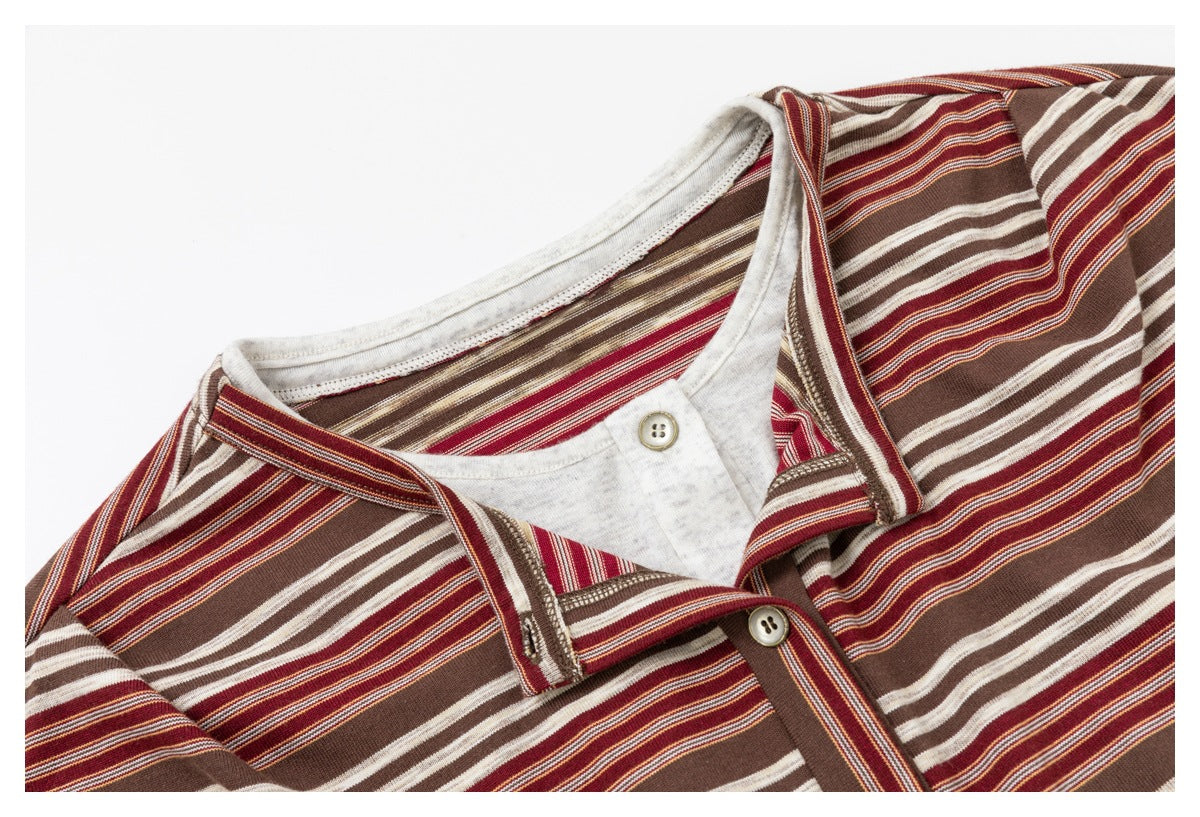 Close-up of the striped top's layered neckline and collar, showing the button placket and contrasting inner layer.