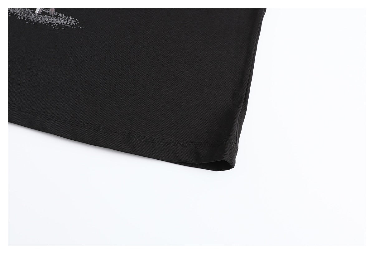 Close-up of the black T-shirt’s stitched bottom hem, with part of a white graphic visible.