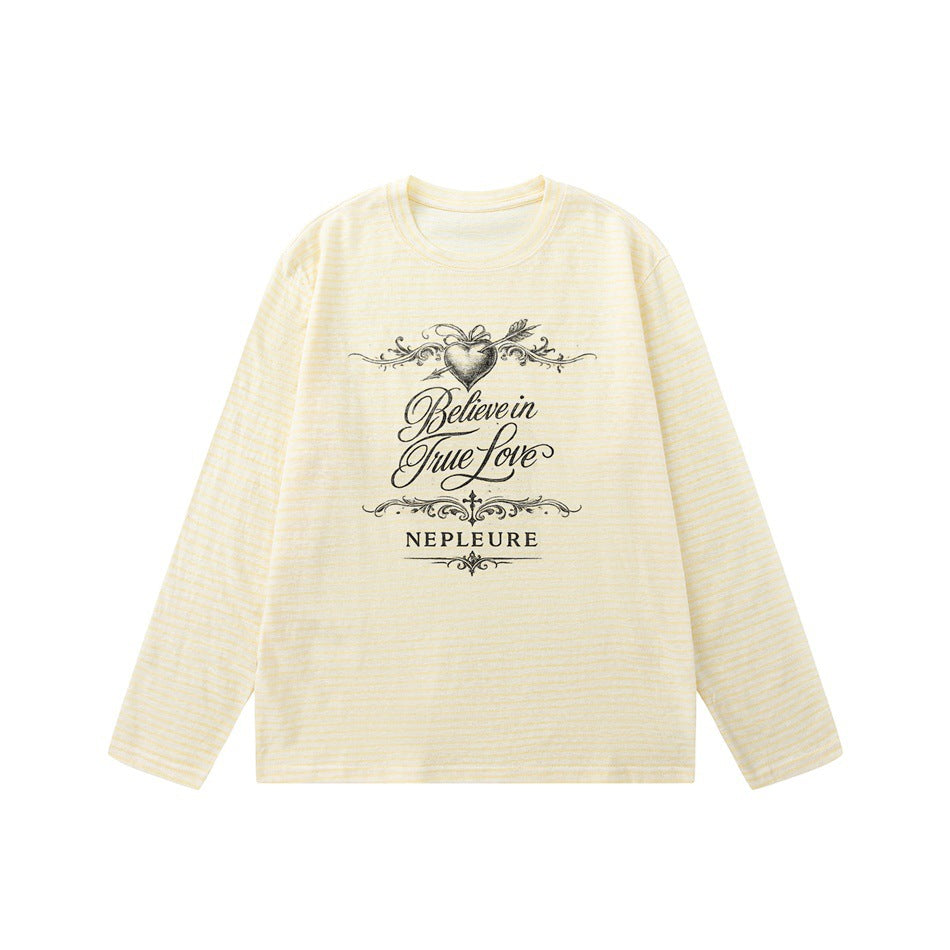 Pale yellow striped long-sleeve crew neck tee with heart and arrow script graphic, flat lay front view
