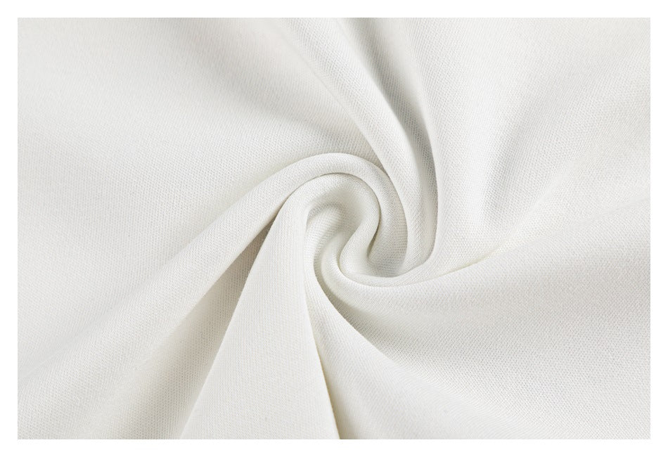 Close-up of white garment fabric gathered into a soft spiral fold.