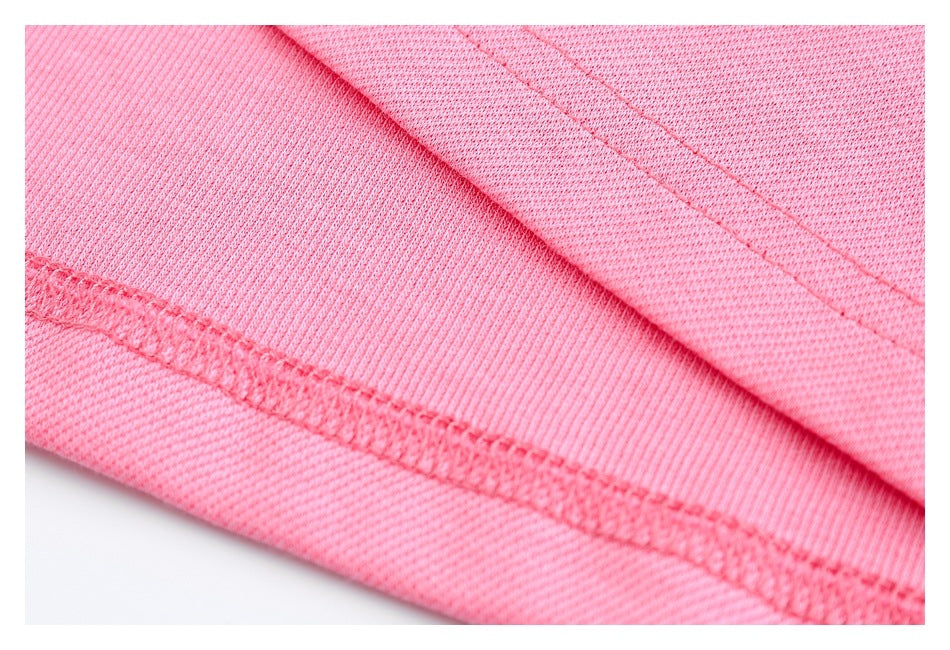Close-up of pink knit fabric showing a folded edge and visible stitching.
