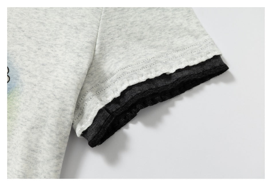 Close-up of a light gray heather knit sleeve with a black layered cuff edge.