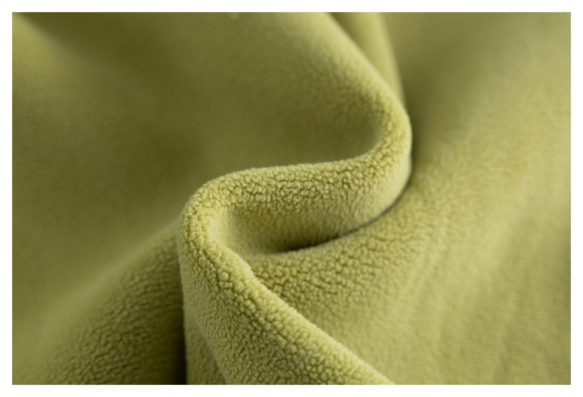 Close-up of olive-green fabric folds highlighting its nubby surface texture.