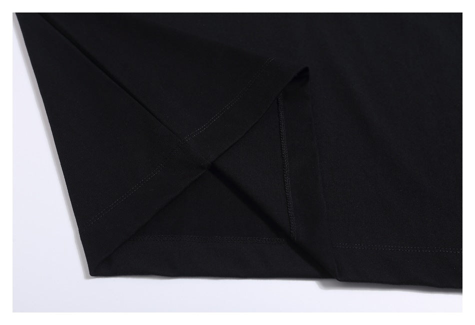 Close-up of the black T-shirt's sleeve and hem stitching.