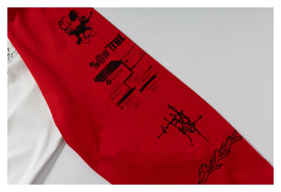 Close-up of black graphic prints on the red sleeve of a white-and-red raglan shirt.