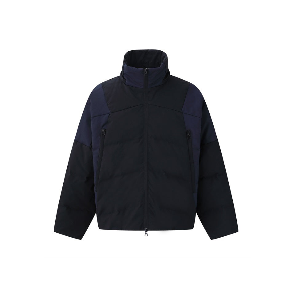 Front view of a black and navy color-block jacket with a high collar, center zipper and two zip pockets.