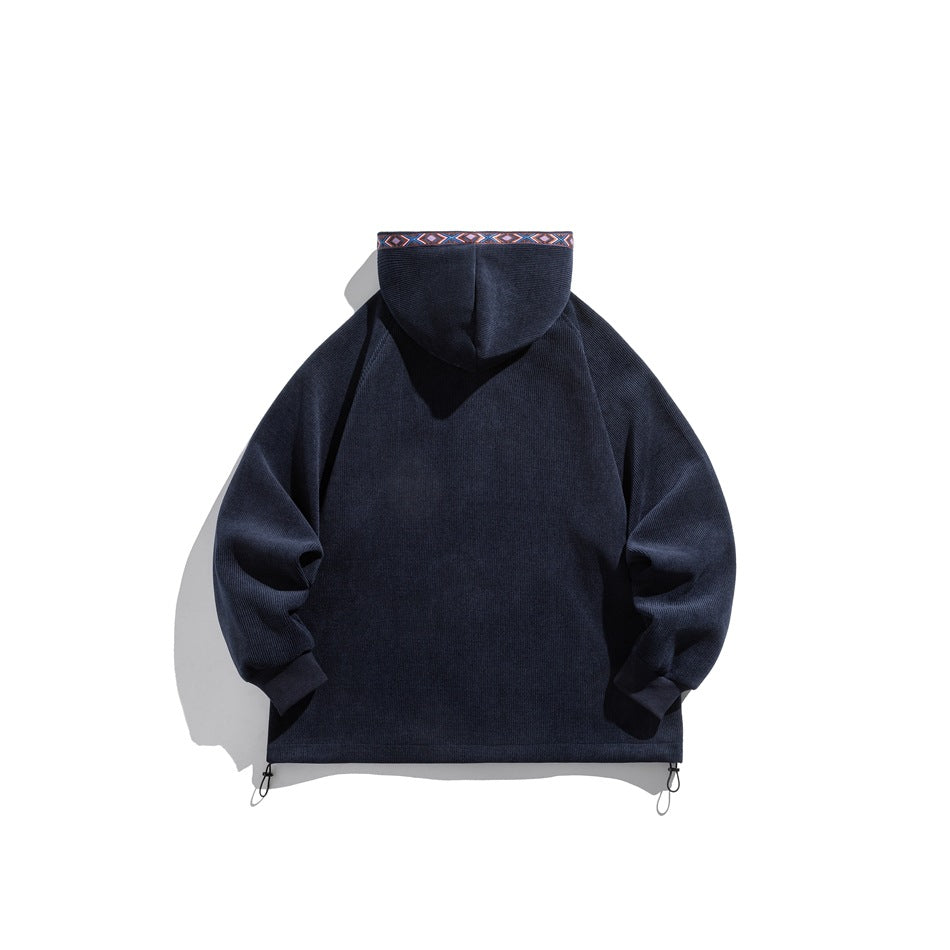 Back view of a navy hooded zip-up jacket with geometric trim along the hood edge and drawcords at the hem.