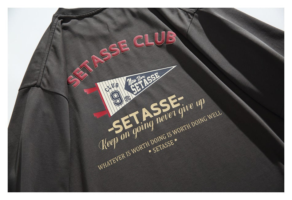 Charcoal T-shirt back with a large red, cream, and white “SETASSE” graphic and motivational text.
