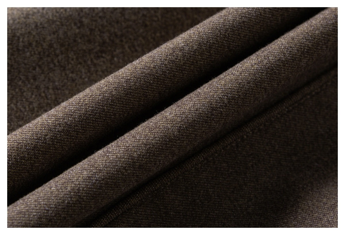 Close-up of dark brown-gray woven garment fabric arranged in soft diagonal folds.