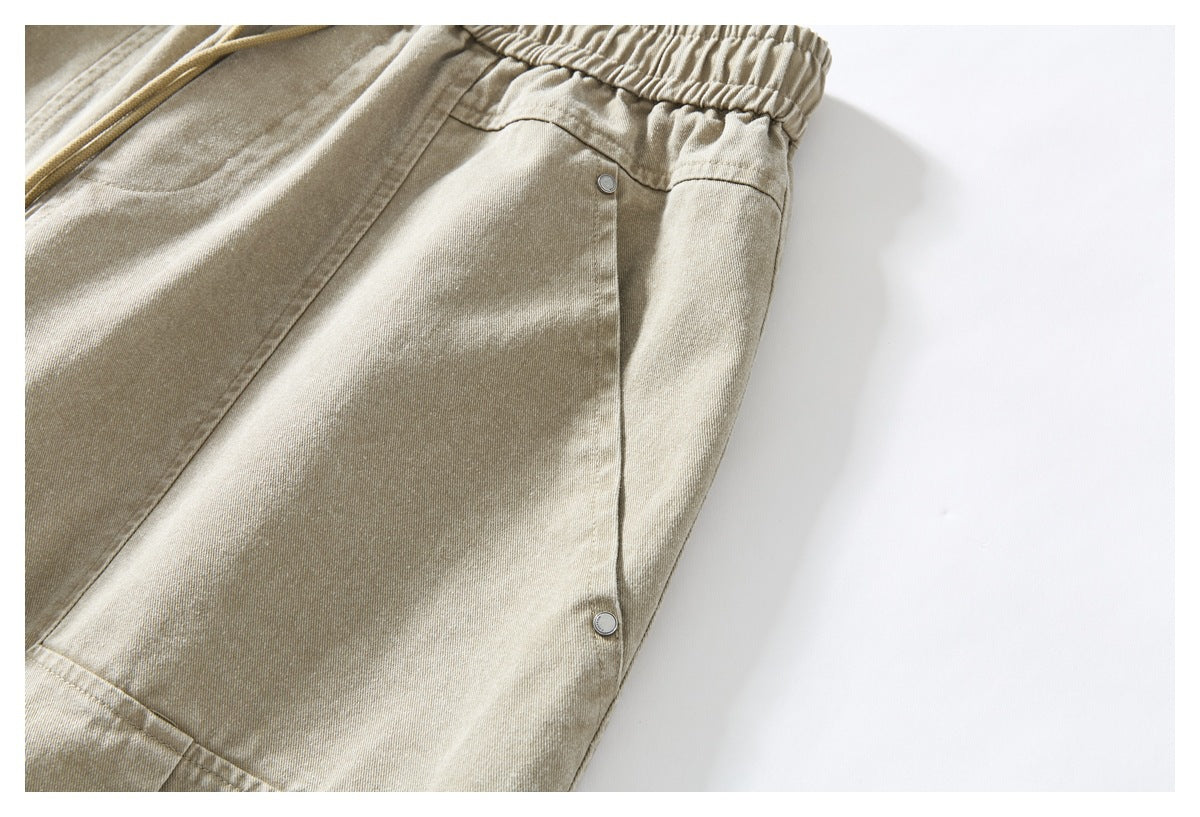 Close-up of a light khaki side panel with seams and two round metal buttons.