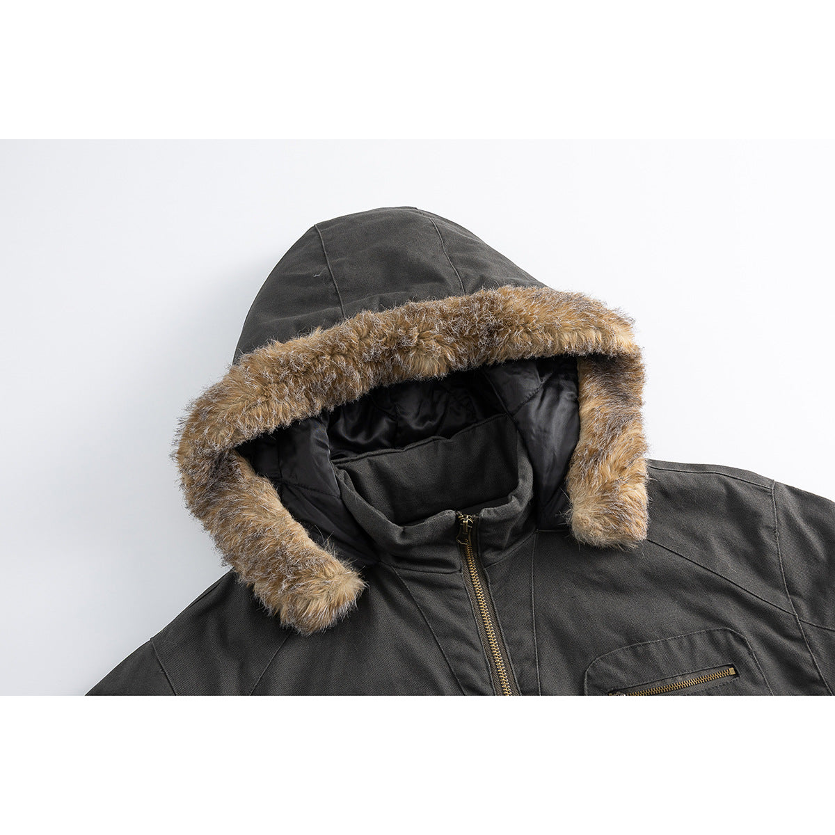 Close-up of a charcoal jacket hood with tan faux-fur trim, black lining, and a brass-tone zipper.