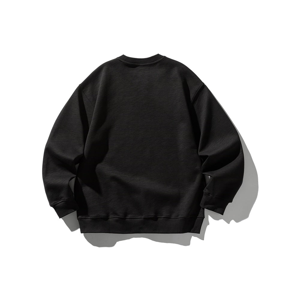 Back view of a black crewneck sweatshirt with a relaxed fit and ribbed cuffs and hem.