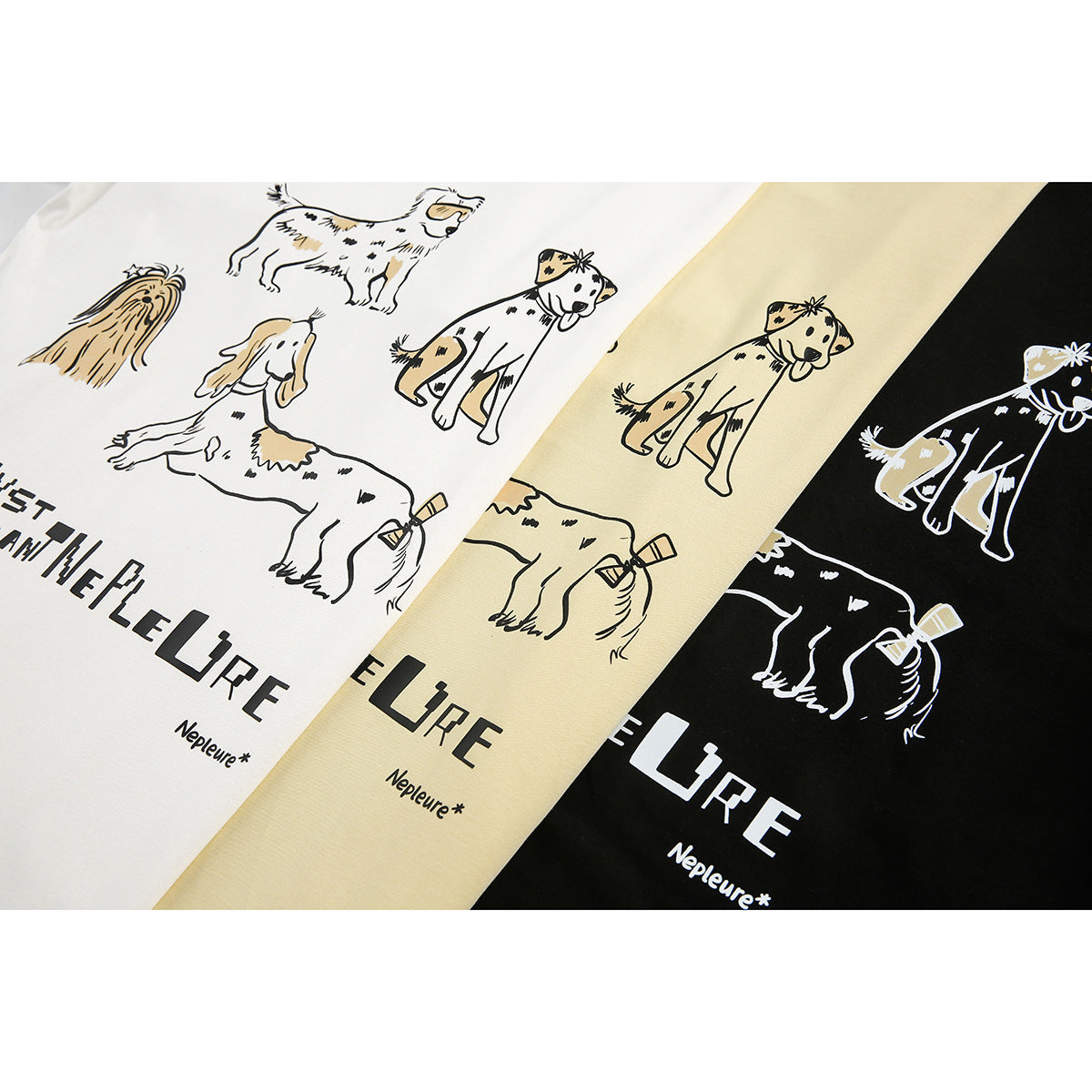 White, pale yellow, and black T-shirts with playful dog illustrations and English lettering, shown close up.