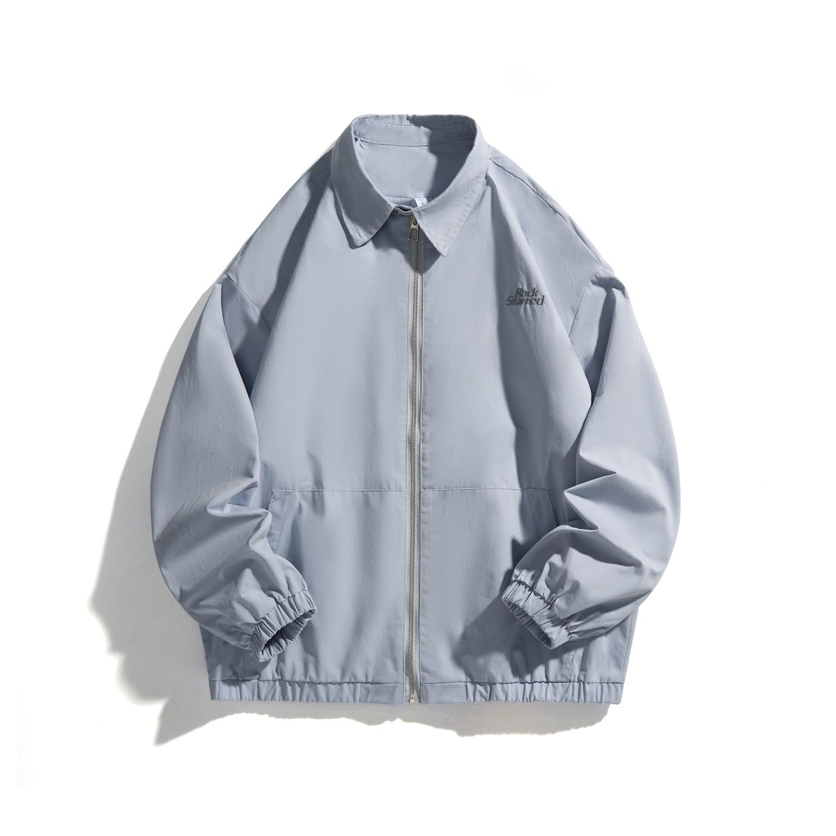 Light blue zip-front jacket with pointed collar, elastic cuffs and hem, front pockets and a small chest embroidery