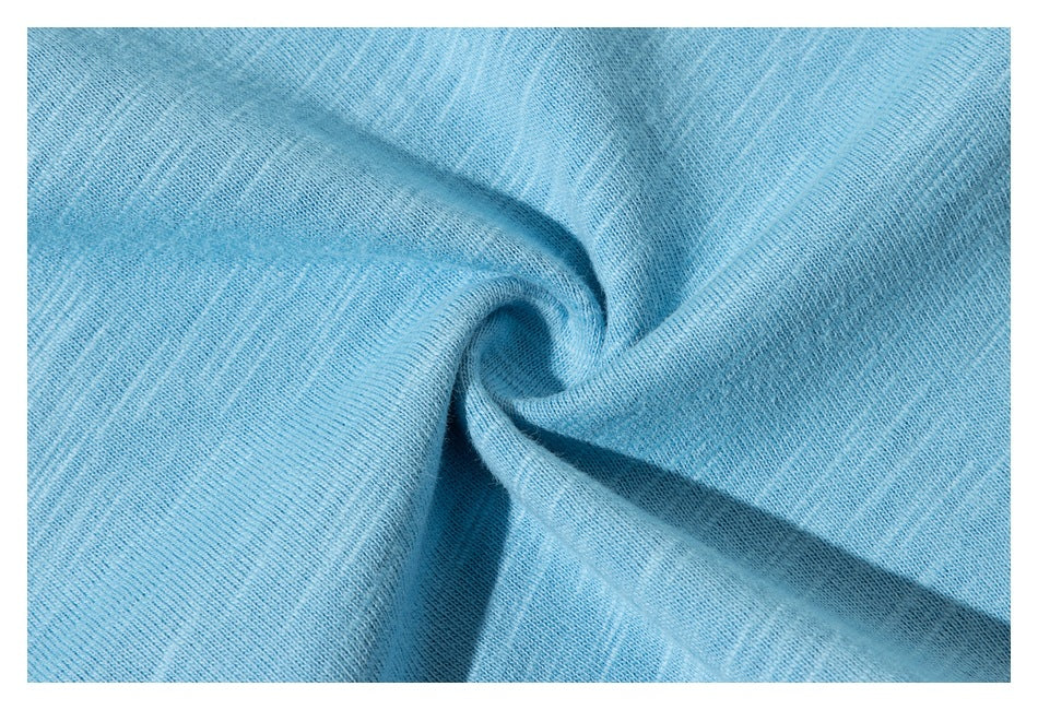 Close-up of light blue shirt fabric gathered into a draped fold.