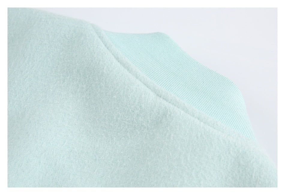 Close-up of mint garment fabric beside a ribbed mint trim.