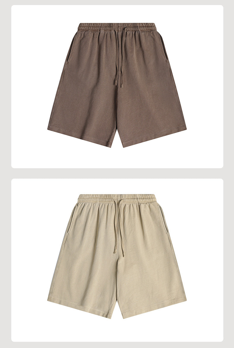 Brown and beige loose shorts shown from the front with elastic waistbands, drawstrings, and side pockets.