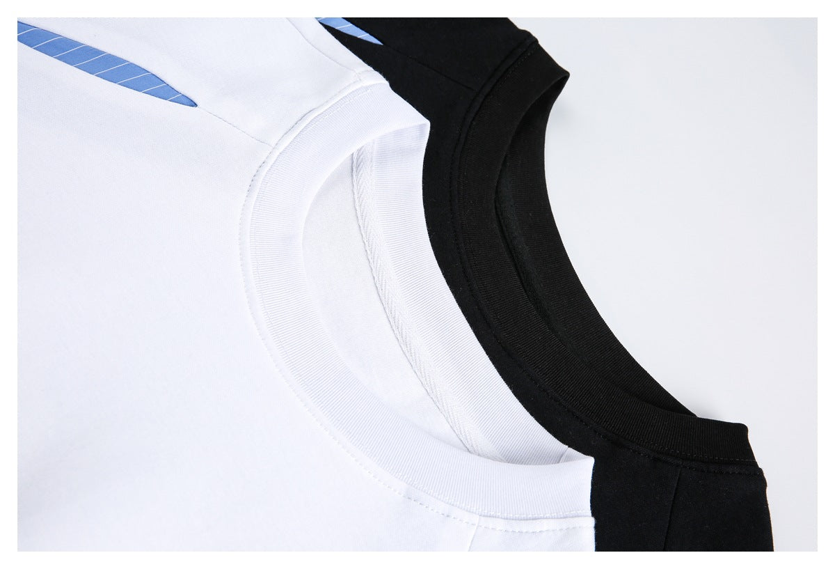 Close-up of white and black crewneck tops with ribbed collars and blue striped accents.