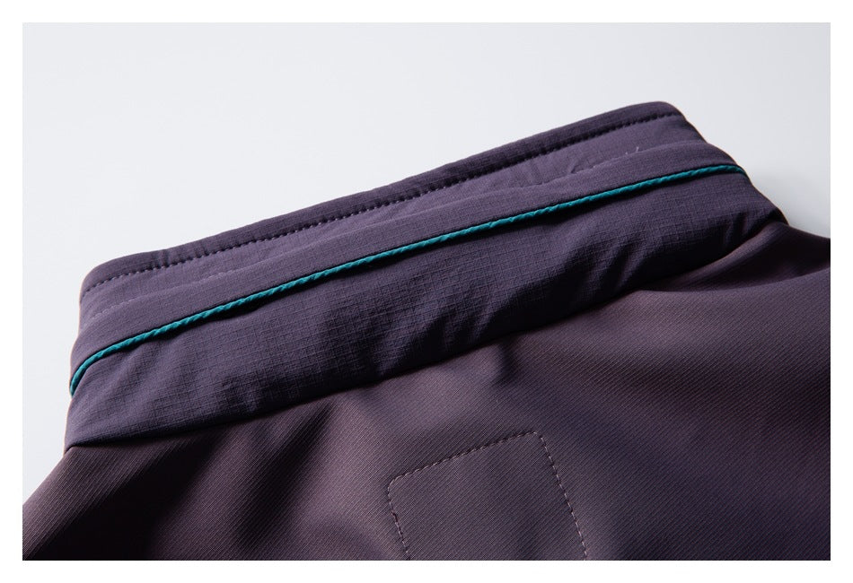 Close-up of the purple pants waistband with teal piping and a stitched rear pocket area.