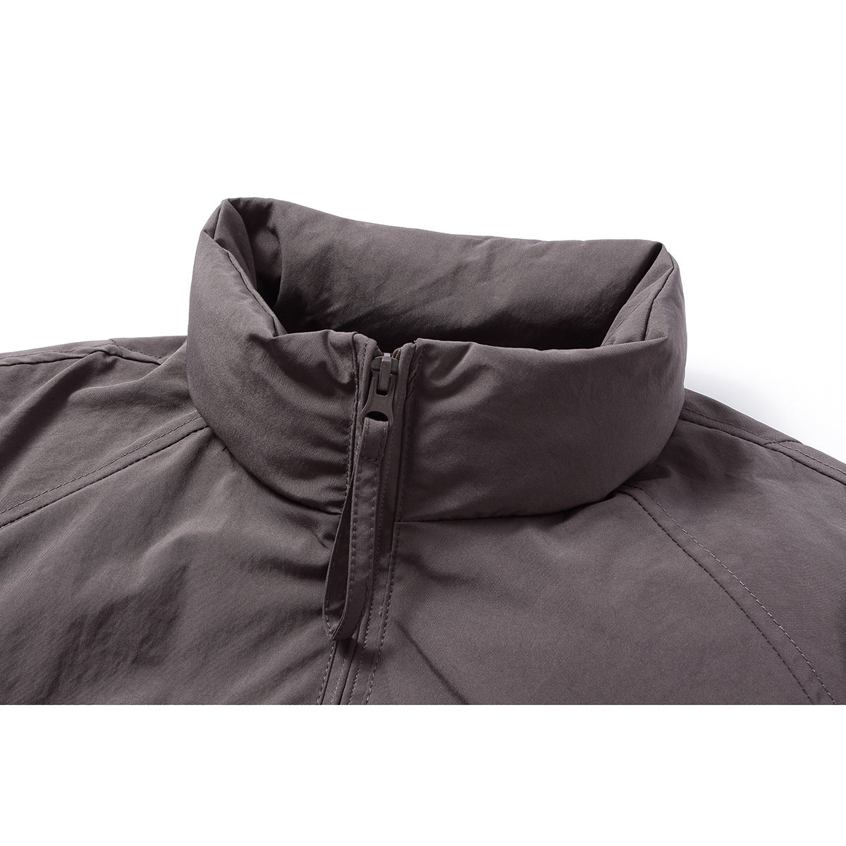 Close-up of a dark gray jacket's tall stand collar and central zipper.