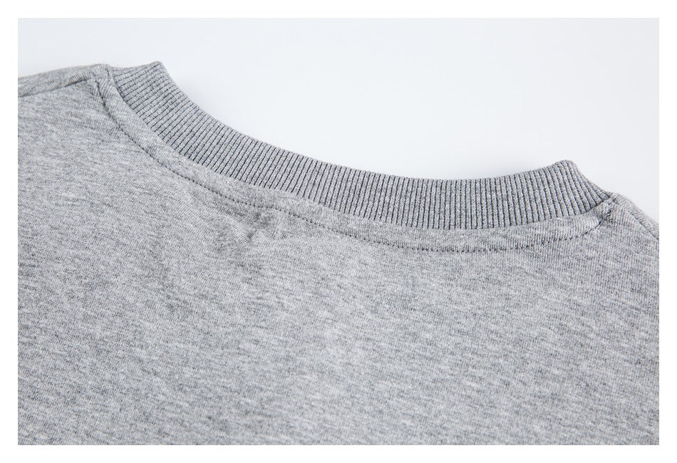 Close-up of the gray heather sweatshirt's ribbed crew neckline and shoulder seams.