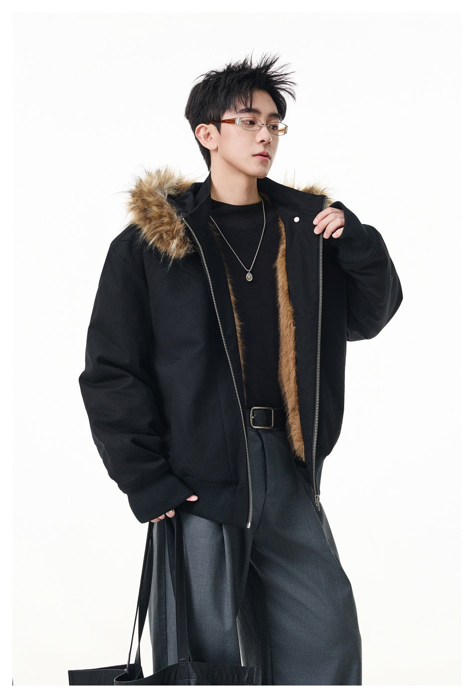 Model wearing a black zip-front jacket with a tan fur-trimmed hood and open front.