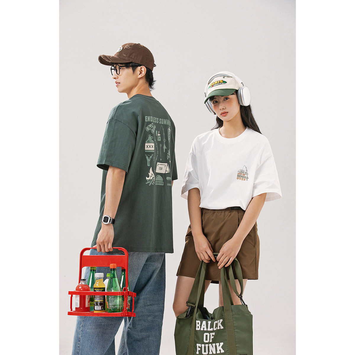 Two models show a white graphic T-shirt from the front and a dark green graphic T-shirt from the back.