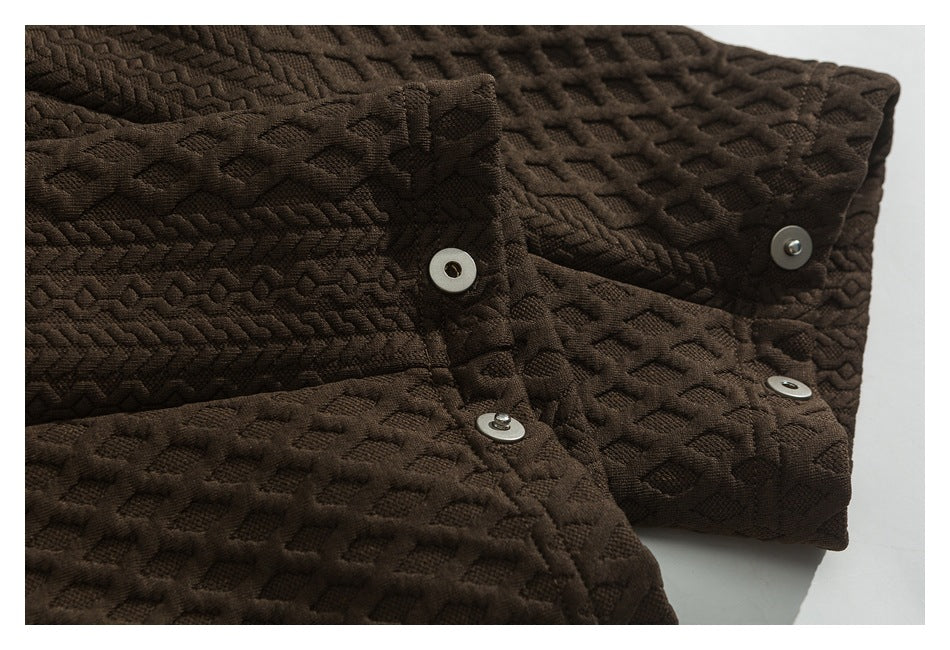 Close-up of the brown jacket's textured front placket and metal snap buttons.
