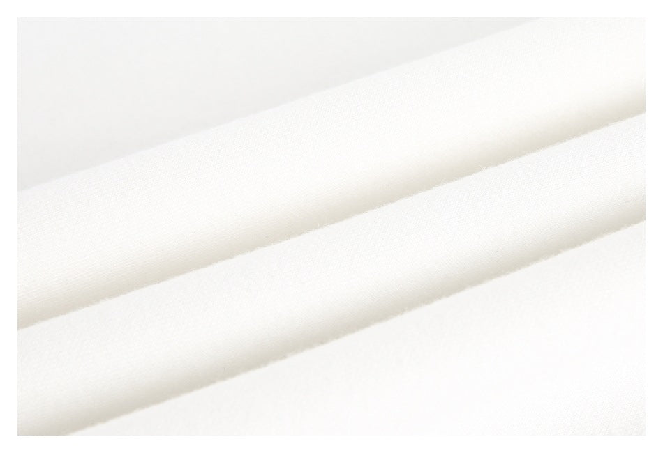 Close-up of smooth white fabric arranged in soft diagonal folds.