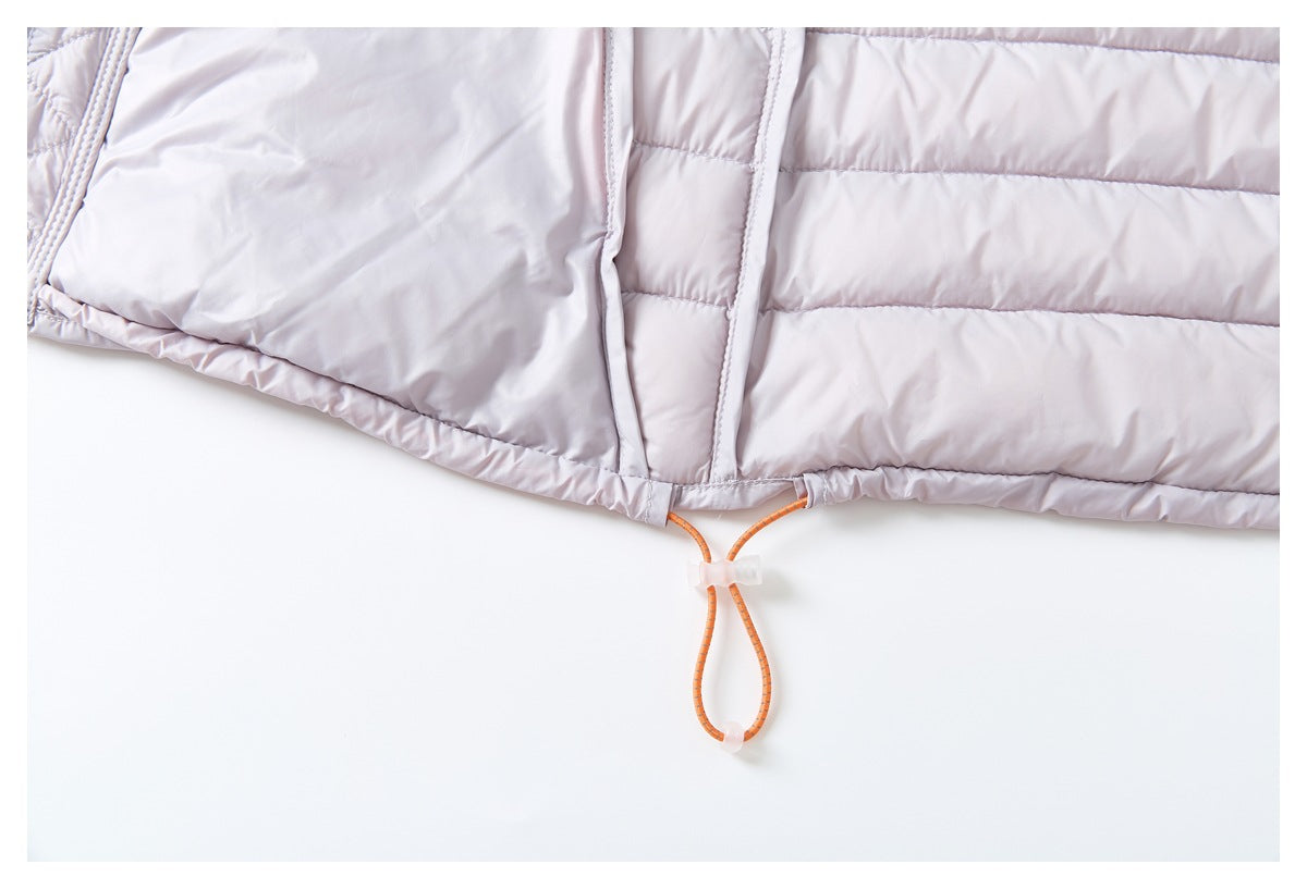 Close-up of a pale lavender quilted jacket hem with an orange adjustable drawcord and clear toggle.
